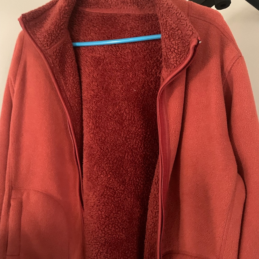 Red coat with pockets and a furry inside.